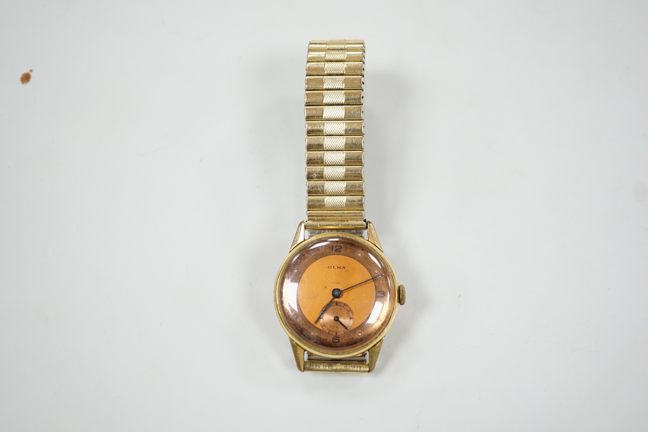 A gentleman's gold plated Olma manual wind wrist watch, case diameter 32mm, on associated flexible bracelet.